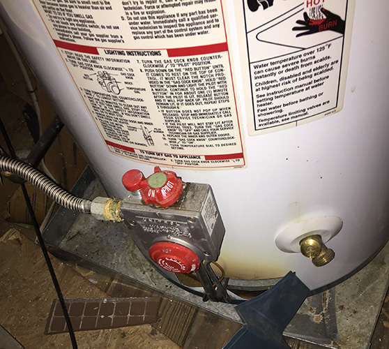 Fire damage on gas water heater in attic.